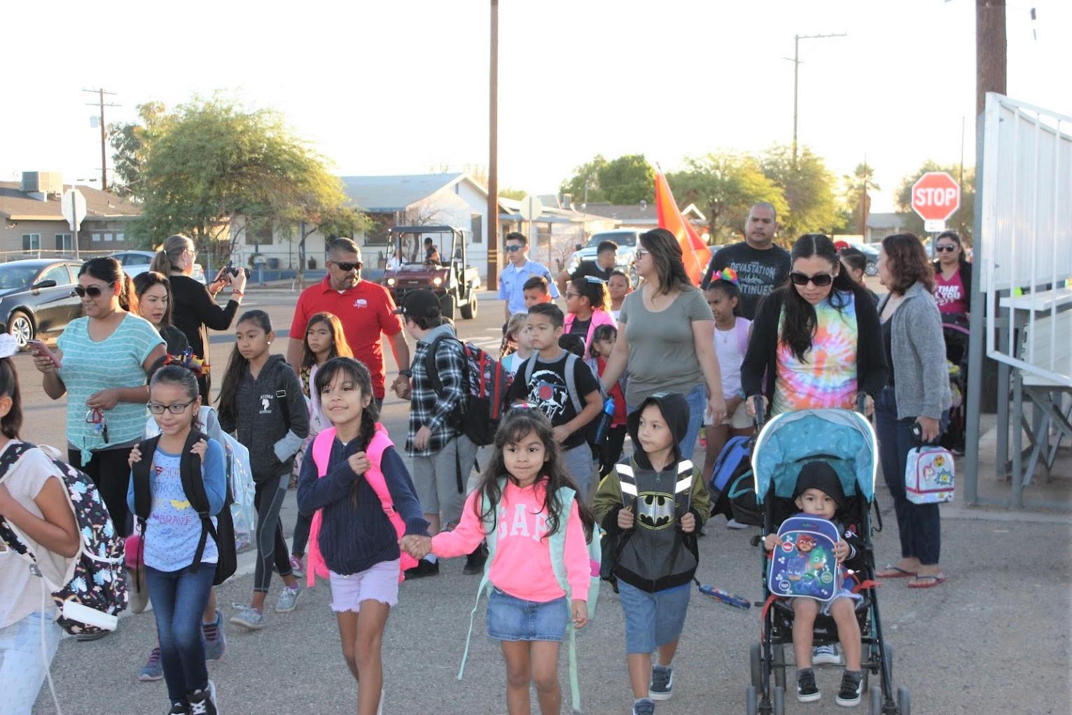 kids walking to school along with parents