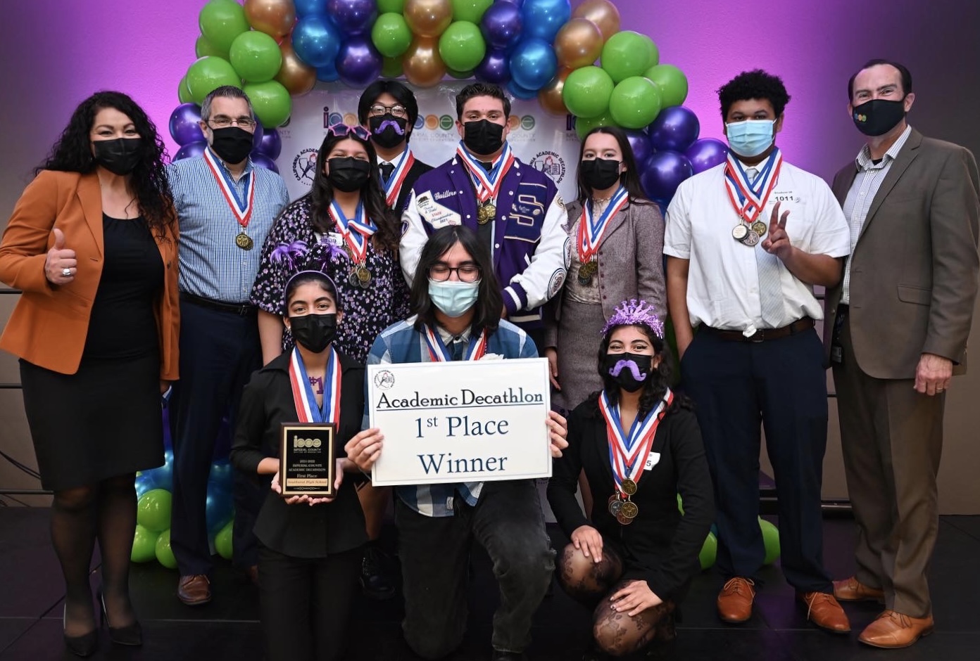 Group of students with medals and award