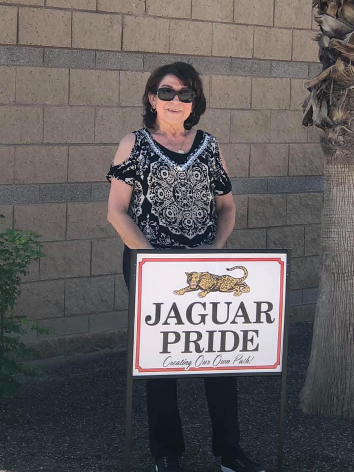 woman in front of school sign