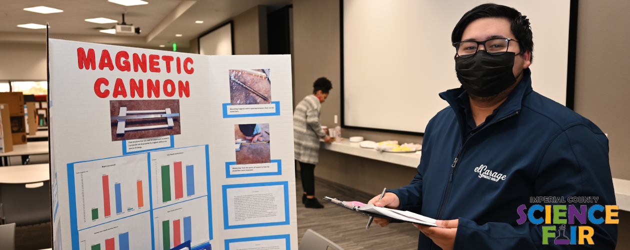 Science Fair - Judge looking at the Magnetic Cannon stand